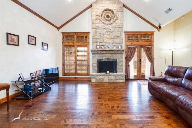 living room with crown molding, plenty of natural light, a fireplace, and dark wood-type flooring