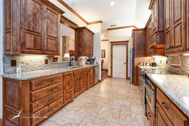 kitchen featuring stainless steel appliances, ornamental molding, sink, and light stone counters