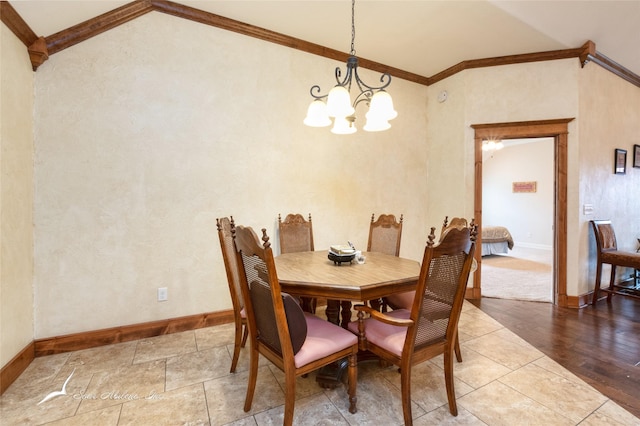 dining area with vaulted ceiling, ornamental molding, and a chandelier