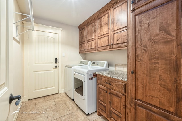 laundry room featuring cabinets and separate washer and dryer