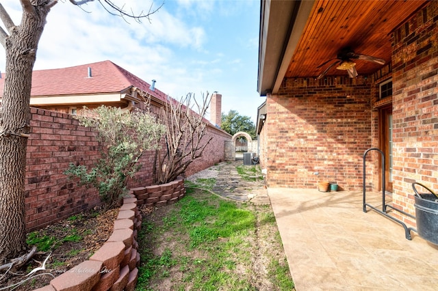 view of yard with a patio, central AC unit, and ceiling fan