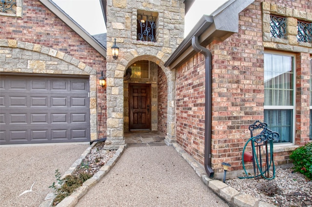 view of exterior entry featuring a garage