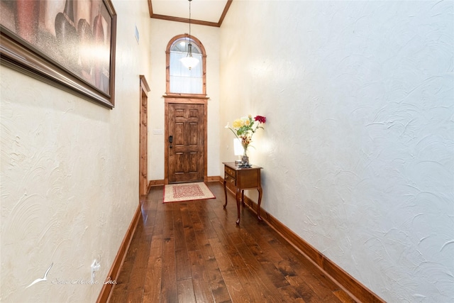 doorway with hardwood / wood-style floors and crown molding