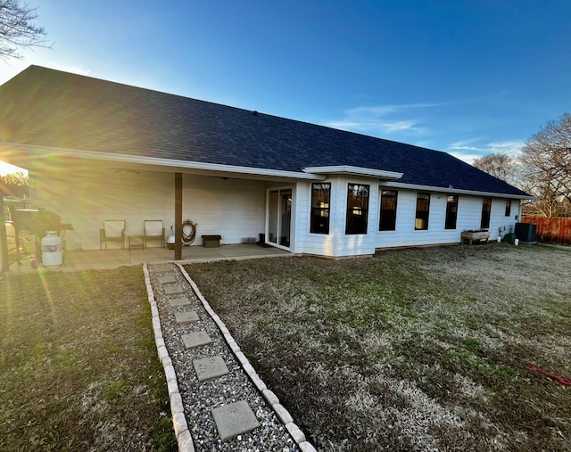 back of house featuring a patio, central AC, and a lawn