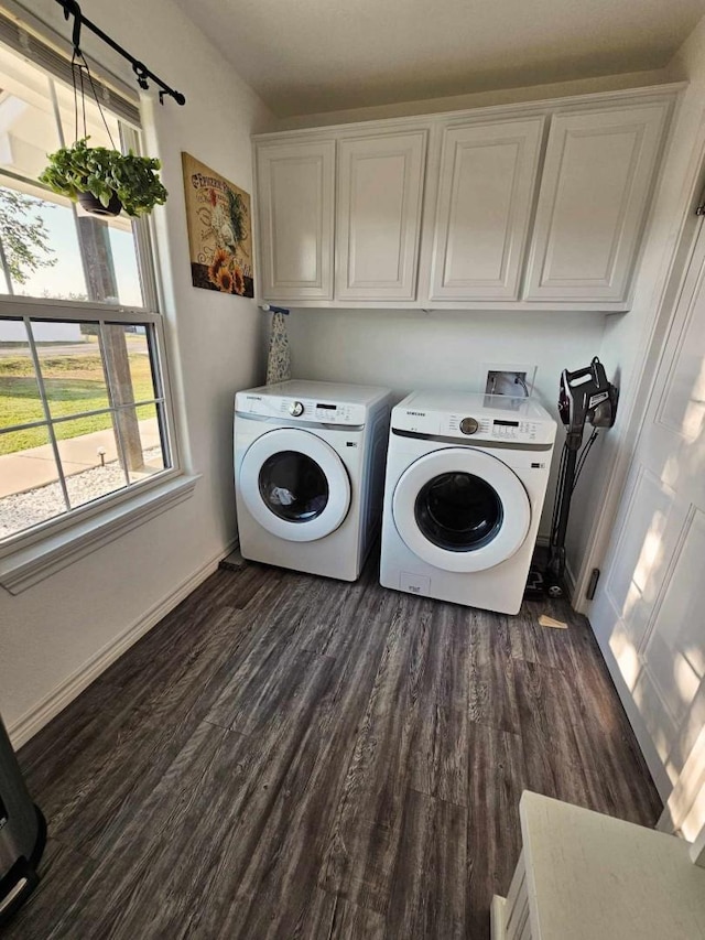 washroom with cabinets, dark hardwood / wood-style floors, and washer and clothes dryer