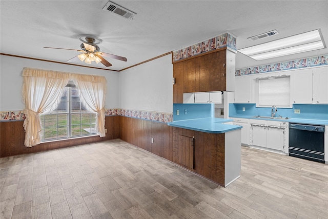 kitchen with sink, white cabinetry, light wood-type flooring, dishwasher, and kitchen peninsula