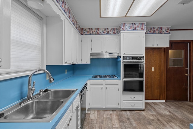 kitchen featuring white cabinetry, light wood-type flooring, sink, and black appliances