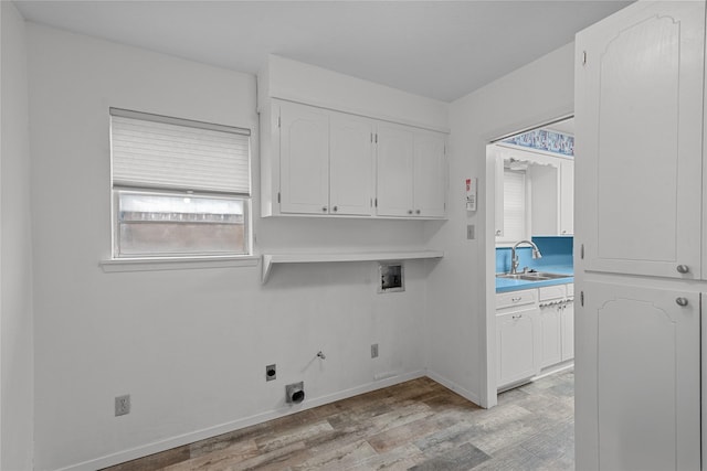 laundry room featuring sink, cabinets, light hardwood / wood-style floors, hookup for a washing machine, and electric dryer hookup