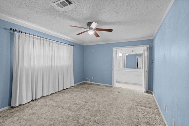 carpeted spare room with crown molding, a textured ceiling, and ceiling fan