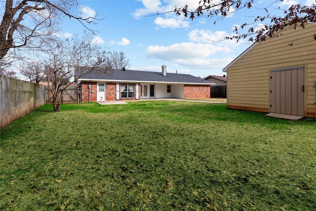 back of property featuring a yard and a patio