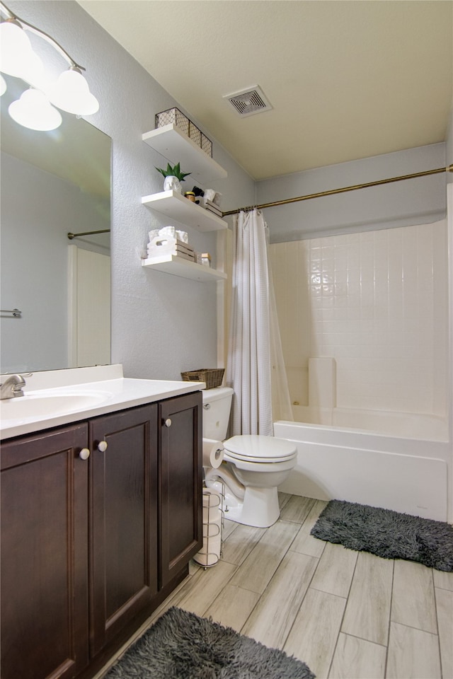 full bathroom with toilet, vanity, and shower / bath combo with shower curtain