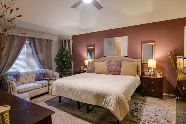 bedroom with a high ceiling, light colored carpet, and ceiling fan