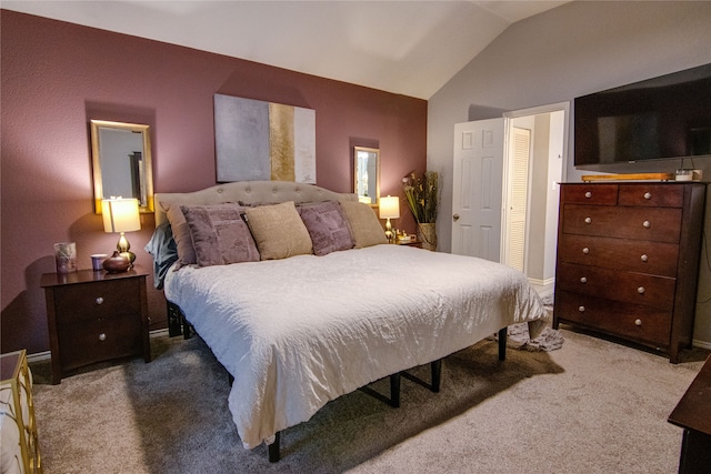 carpeted bedroom with vaulted ceiling