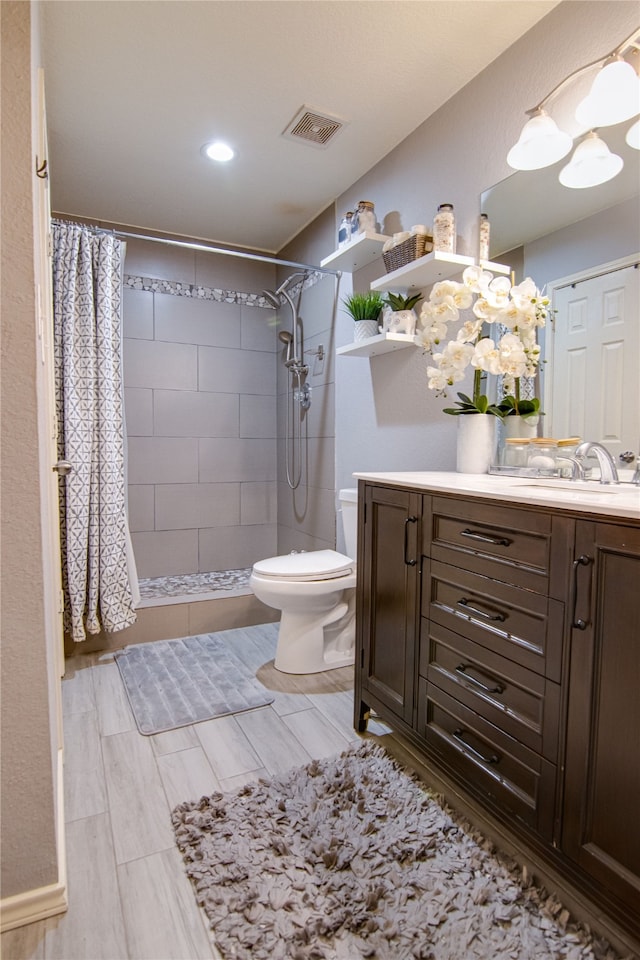 bathroom with vanity, curtained shower, and toilet