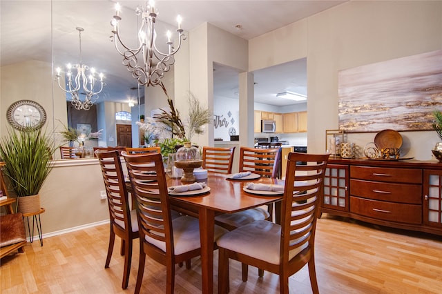 dining area with an inviting chandelier and light wood-type flooring