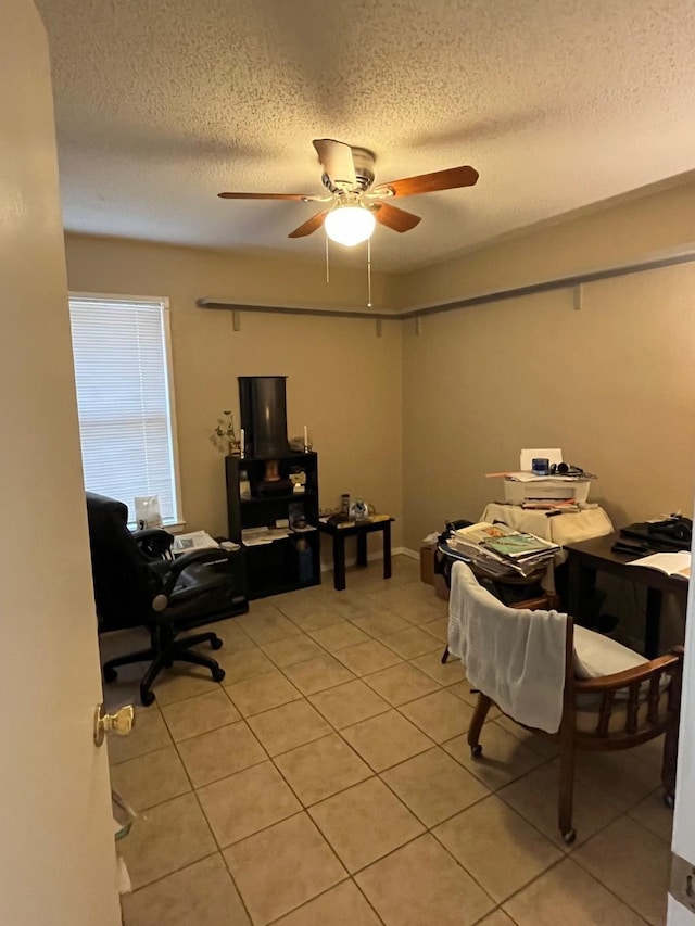 office area with light tile patterned flooring, a textured ceiling, and ceiling fan