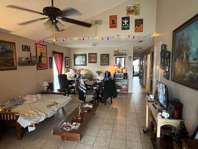 bedroom with light tile patterned floors, visible vents, and lofted ceiling