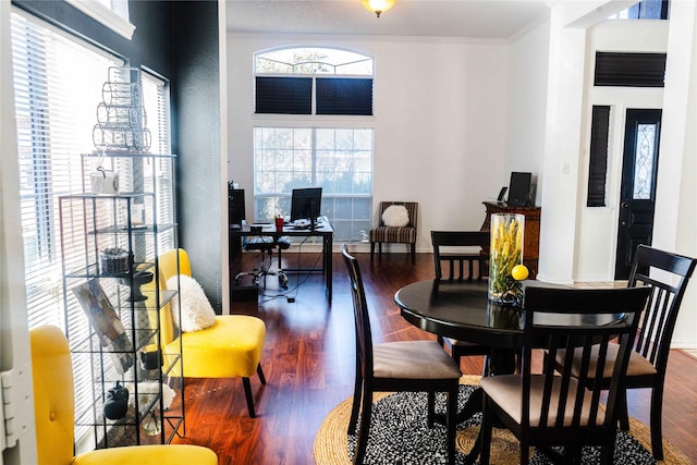 dining area with ornamental molding and hardwood / wood-style floors