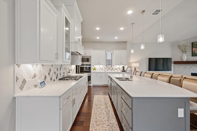 kitchen with white cabinetry, sink, and a kitchen bar