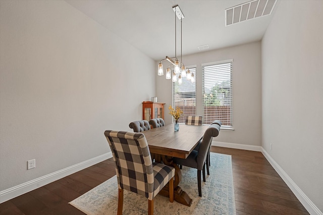 dining space featuring a chandelier and dark hardwood / wood-style flooring