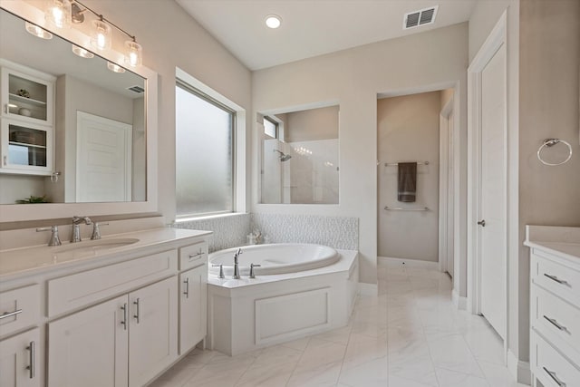 bathroom featuring vanity and separate shower and tub