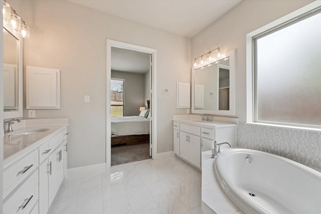 bathroom featuring vanity and tiled bath