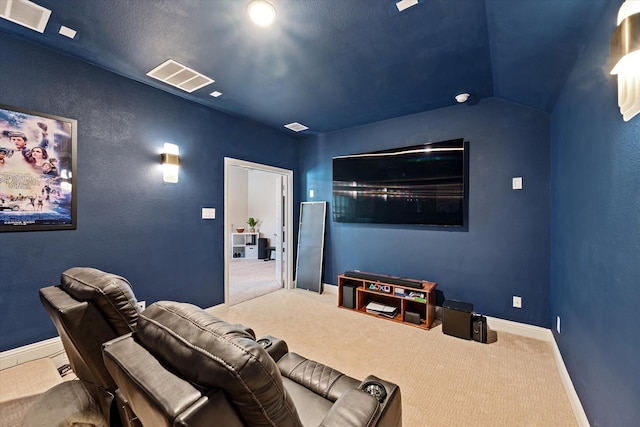 carpeted cinema room with lofted ceiling