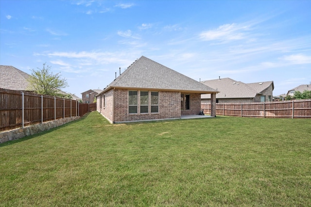 rear view of property with a lawn and a patio area