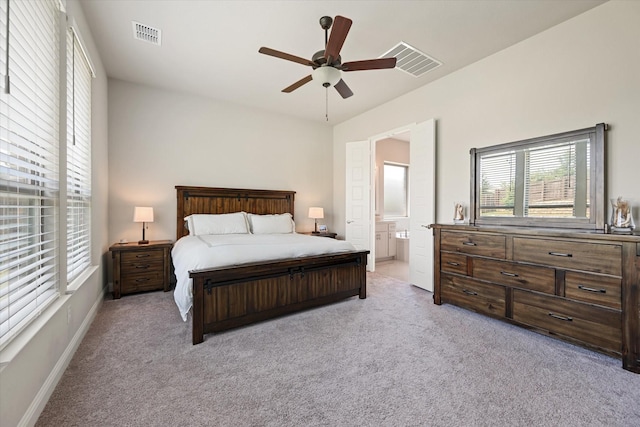 carpeted bedroom featuring ceiling fan and ensuite bathroom