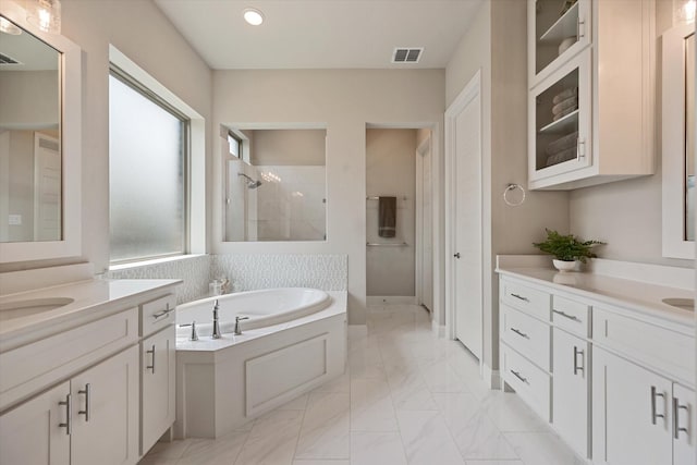 bathroom featuring vanity and shower with separate bathtub