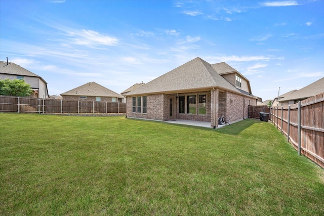 back of house featuring a yard and a patio area