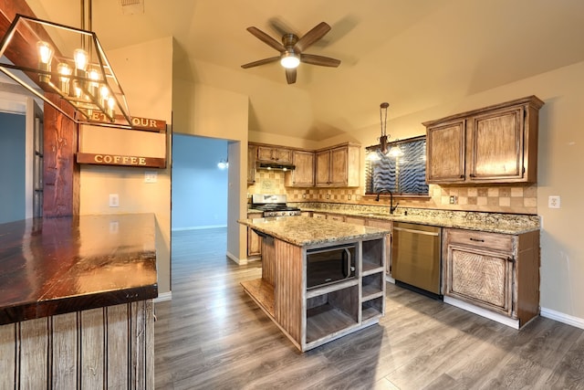 kitchen with stainless steel appliances, dark hardwood / wood-style floors, pendant lighting, and backsplash