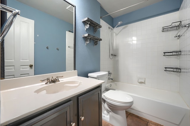 full bathroom with vanity, tiled shower / bath combo, tile patterned floors, and toilet