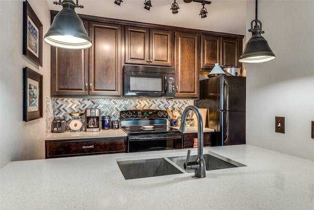 kitchen with sink, pendant lighting, decorative backsplash, and black appliances