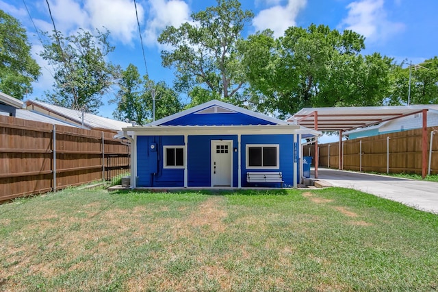 view of outbuilding with driveway and fence