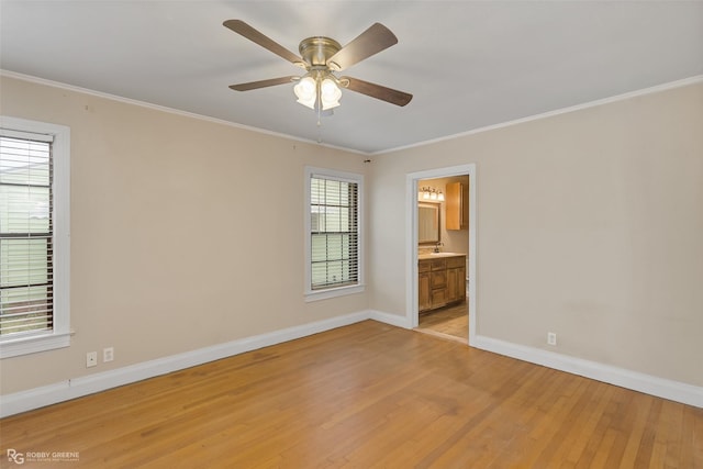 spare room featuring crown molding, sink, ceiling fan, and light hardwood / wood-style flooring