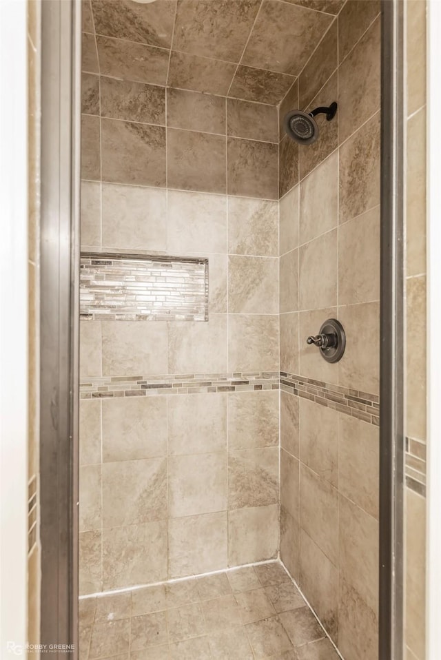 bathroom with a tile shower