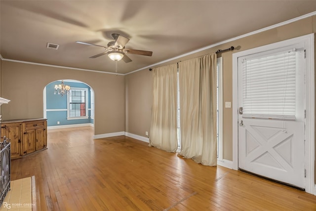 living room with ceiling fan with notable chandelier, light hardwood / wood-style flooring, and ornamental molding