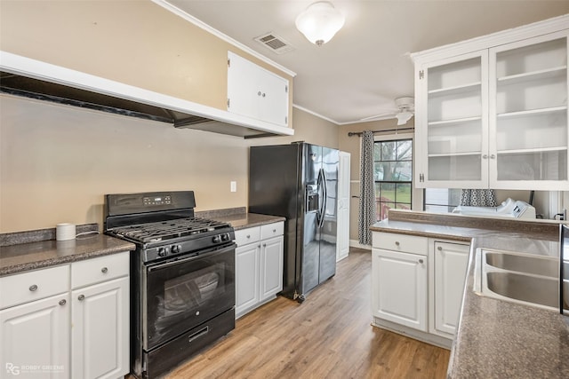 kitchen featuring sink, white cabinets, black appliances, crown molding, and light hardwood / wood-style flooring