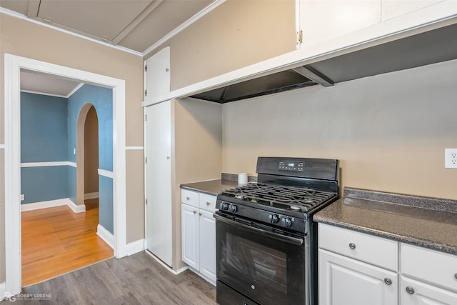 kitchen with white cabinetry, black range with gas stovetop, ornamental molding, and light hardwood / wood-style floors