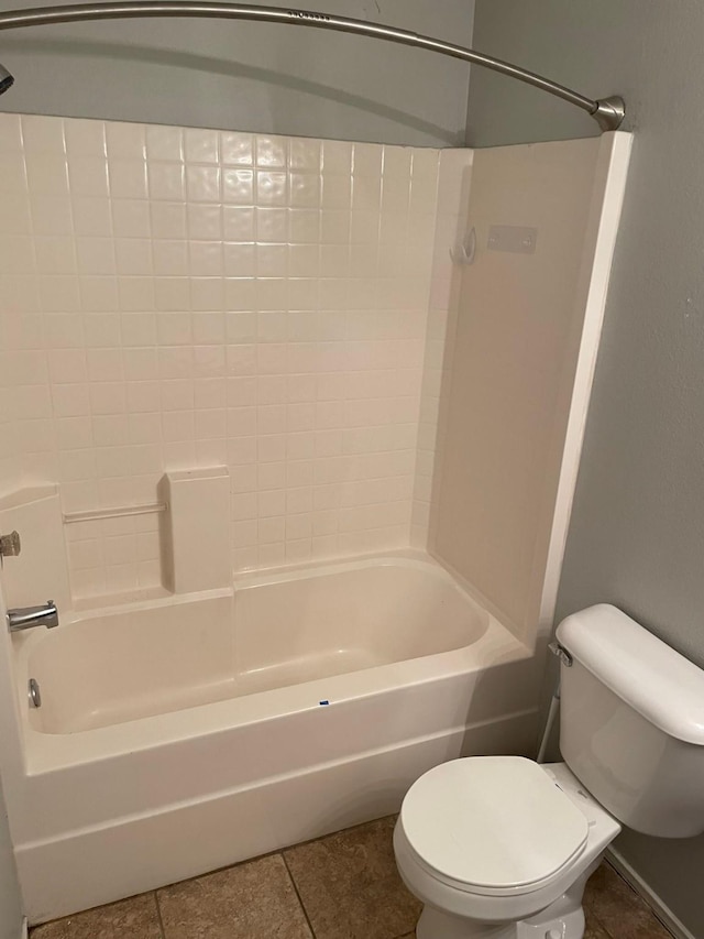 bathroom featuring tile patterned floors, tub / shower combination, and toilet