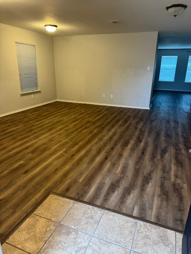 empty room with dark hardwood / wood-style floors