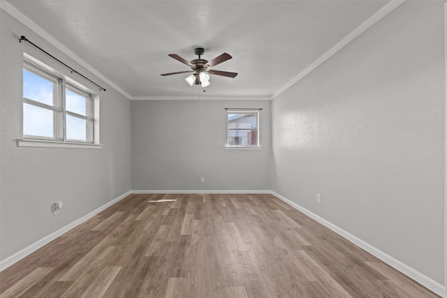 unfurnished room with light hardwood / wood-style flooring, ornamental molding, and a healthy amount of sunlight