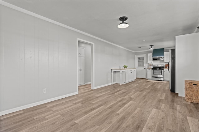 unfurnished living room with ornamental molding and light wood-type flooring