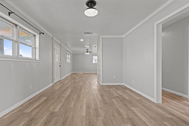 spare room featuring crown molding, ceiling fan, and light hardwood / wood-style flooring