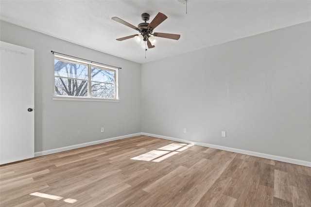 empty room with ceiling fan and light wood-type flooring