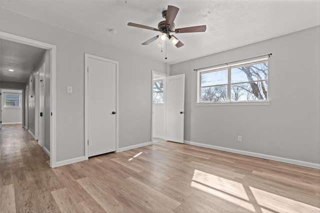 spare room featuring light hardwood / wood-style floors and ceiling fan