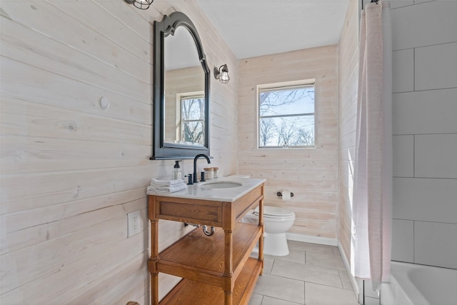 full bathroom featuring shower / bath combo, tile patterned flooring, vanity, toilet, and wood walls