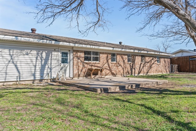 rear view of property with a yard and a patio