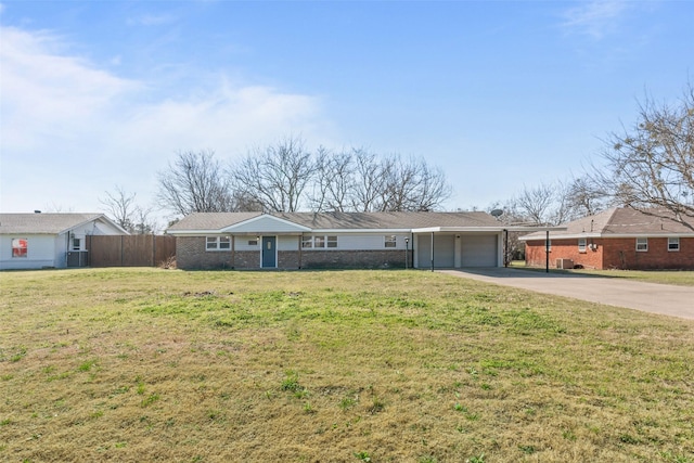 ranch-style home with a garage and a front lawn